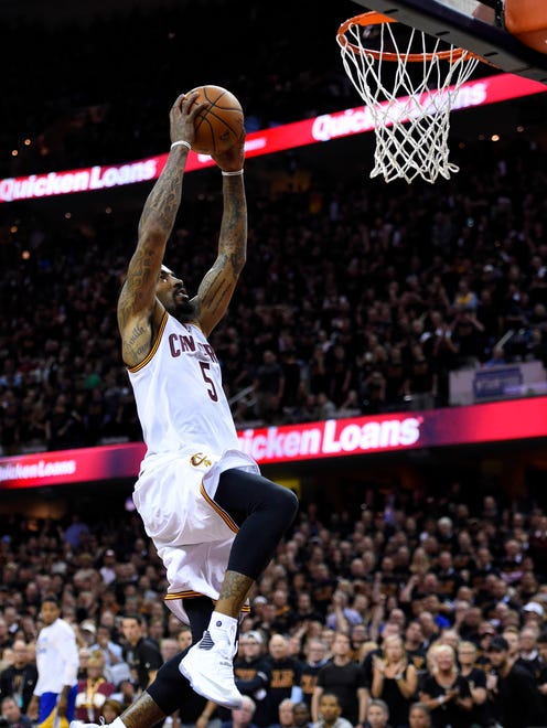 Cleveland Cavaliers guard J.R. Smith (5) dunks the ball against the Golden State Warriors during the fourth quarter in Game 6 of the NBA Finals at Quicken Loans Arena.
