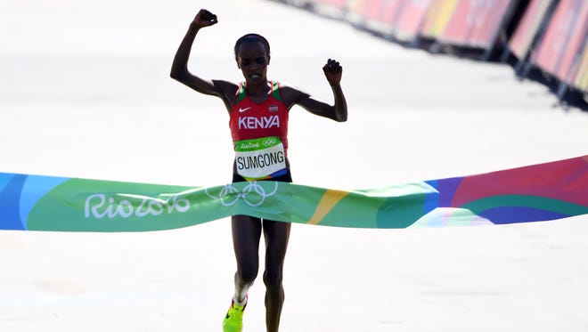 Jemima Jelagat Sumgong of Kenya celebrates after winning the women's marathon in the Rio 2016 Summer Olympic Games at Sambodromo.