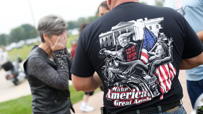 Sen. Joni Ernst reacts to a riders T-shirt Saturday, Aug. 27, 2016, before the second annual Roast and Ride to the Iowa State Fairgrounds in Des Moines.