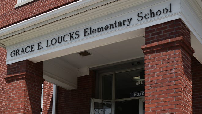 File - Students take photos on the last day of school at Loucks Elementary before the building closed in 2015.