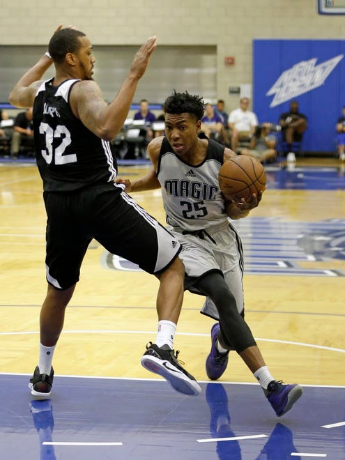 Orlando Magic's Wesley Iwundu (25) drives around Charlotte Hornets' Kris Joseph (32) during the first half of an NBA Summer League game in Orlando.