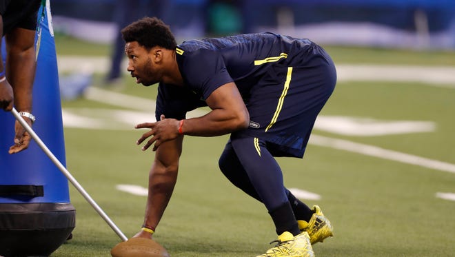 Texas A&M DE Myles Garrett prepares to show simulated quickness off the snap Sunday at the scouting combine.