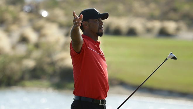 Tiger Woods motions that his ball went right after teeing off on the 18th hole during the final round at the Hero World Challenge  on Dec. 4 in Nassau, Bahamas.