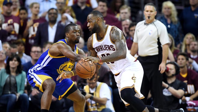 Cleveland Cavaliers forward LeBron James (23) drives to the basket against Golden State Warriors forward Harrison Barnes (40) during the second quarter in Game 3 of the NBA Finals at Quicken Loans Arena.