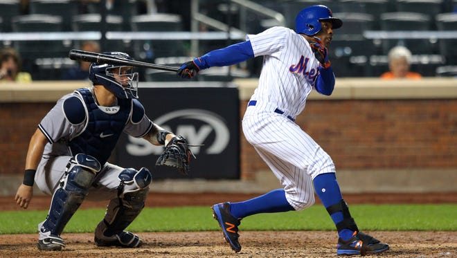 Mets right fielder Curtis Granderson (3) follows through on a grand slam against the New York Yankees during the ninth inning at Citi Field on Thursday, Aug. 17, 2017.