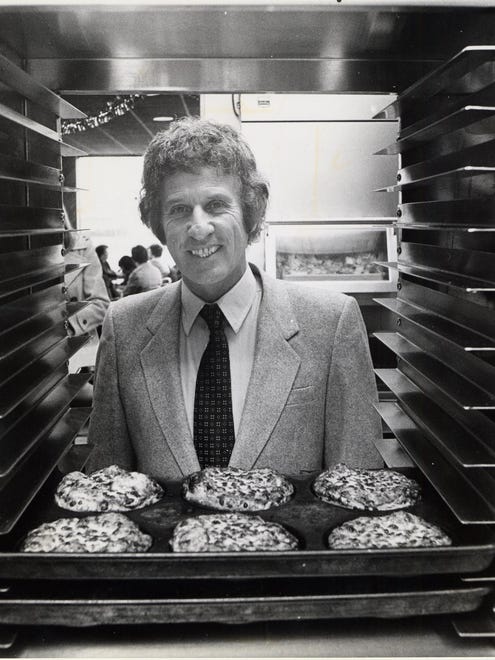 In 1980, Little Caesars Mike Ilitch is photographed with his pizza.