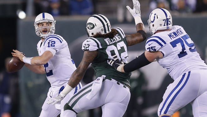 New York Jets defensive tackle Leonard Williams (92) is held by Indianapolis Colts offensive guard Jack Mewhort (75) as quarterback Andrew Luck (12) looks to pass during the 1st quarter at MetLife Stadium in East Rutherford, N.J., on Monday, Dec. 5, 2016. The penalty resulted in a 1st and 20 for the Colts.