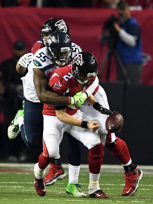 Atlanta Falcons quarterback Matt Ryan (2) fumbles the ball against the Seattle Seahawks during the fourth quarter in the NFC Divisional playoff at Georgia Dome.