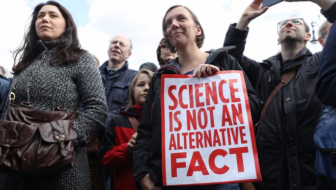 A woman holds a sign during the March for Science demonstration in Berlin, Germany.