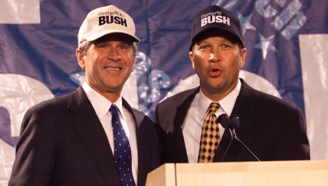 Kasich abandons his presidential bid and endorses George W. Bush during a press conference in Washington on July 14, 1999.
