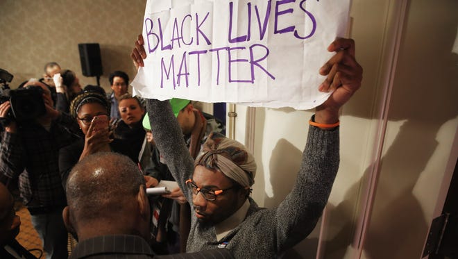 A Black Lives Matter protester is kept out of the main ballroom during the U.S. Conference of Mayors 84th Winter Meeting at the Capitol Hilton on Washington, D.C., on Jan. 20, 2016.