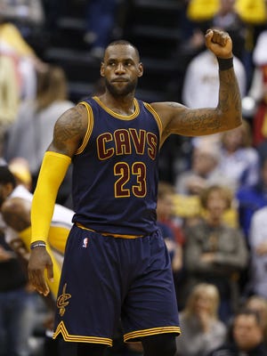 Cleveland Cavaliers forward LeBron James reacts after making a free throw to clinch the win with one second to go against the Indiana Pacers.
