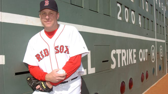 Schilling poses against the Green Monster at Fenway Park in 2004.