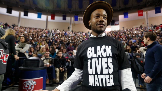 Liberty University student Jeff Long, of Washington DC., wears a Black Lives Matter t-shirt as he looks for a seat prior to a speech by Republican presidential candidate Donald Trump. The speech took place at Liberty University in Lynchburg, Va., on Jan. 18, 2016.