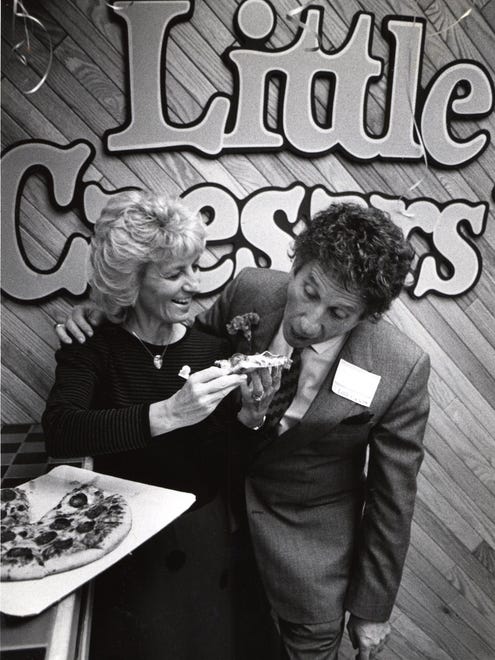 MARIAN AND MIKE ILITCH, owners of Little Caesars izza restaurants, sample the main dish at the opening of their 1,000th store Tuesday in Bloomfield Township in March of 1986..