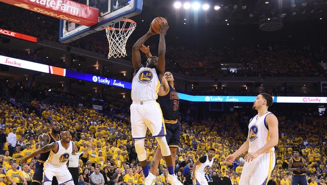 Golden State Warriors forward Draymond Green (23) grabs a rebound against Cleveland Cavaliers forward Richard Jefferson (24) during the first half in game one of the NBA Finals at Oracle Arena.