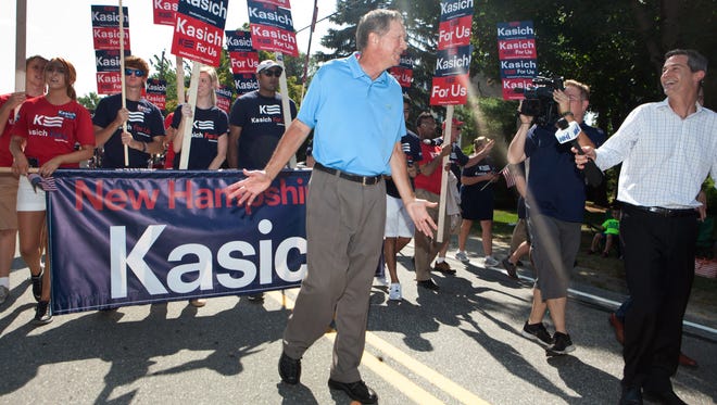 Kasich marches in the annual Labor Day parade on Sept. 7, 2015, in Milford, N.H.