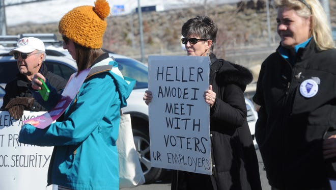 Protestors assemble outside as Senator Dean Heller and Representative Mark Amodei participate in the Carson City Chamber of Commerce monthly Soup's On! event at the Gold Dust West hotel and casino in Carson City on Feb. 22, 2017.