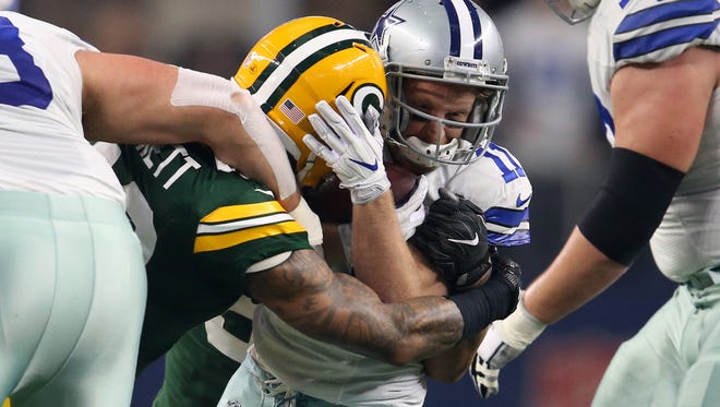 Dallas Cowboys wide receiver Cole Beasley (11) runs the ball against Green Bay Packers strong safety Morgan Burnett (42) during the first quarter in the NFC Divisional playoff game at AT&T Stadium.
