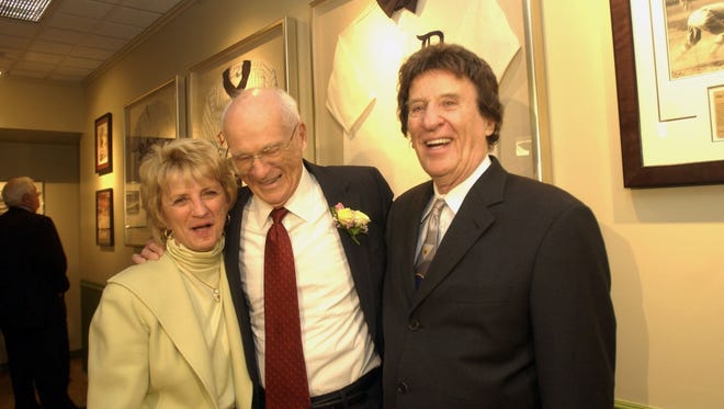 STORY:Ernie Harwell:
Marian Ilitch stands with  Ernie Harwell and her husband Mike Ilitch during a reception for  Harwells in the new "Lulu and Ernie Harwell Collection" room at the Detroit Public Library in Detroit in 2004.