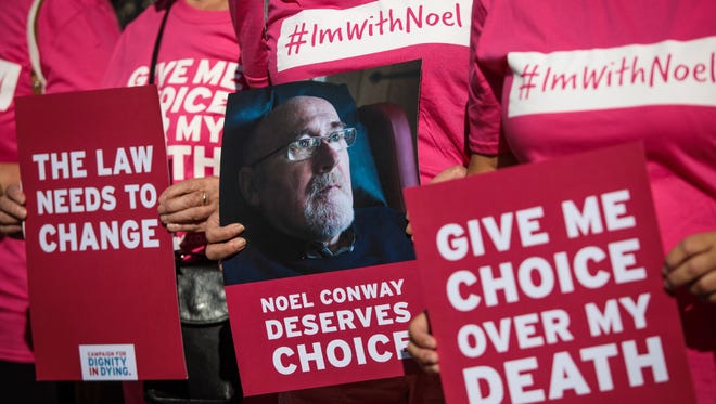 Supporters of Noel Conway from the campaign group Dignity in Dying stand with placards outside Britain's High Court on July 17.
