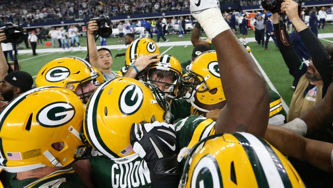 The Green Bay Packers celebrates with kicker Mason Crosby (2) after they defeated the Dallas Cowboys.