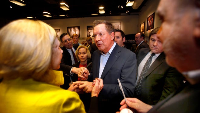Kasich is greeted after speaking at a Politics and Eggs Breakfast with state political activists and area business leaders at Saint Anselm College in Manchester, N.H., on March 24, 2015.