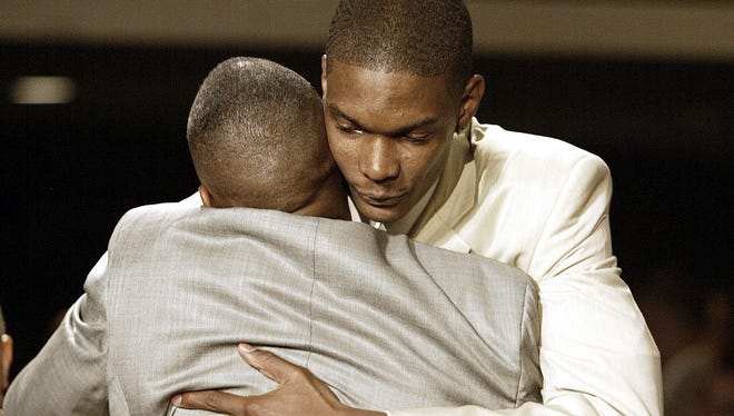 Chris Bosh gets a hug after being selected by the Toronto Raptors in the 2003 NBA Draft in New York City.