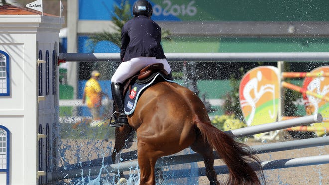 Ramiro Quiantana of Argentina aboard Appy Cara miss a jump during the equestrian open jumping qualification in the Rio 2016 Summer Olympic Games at Olympic Equestrian Centre.