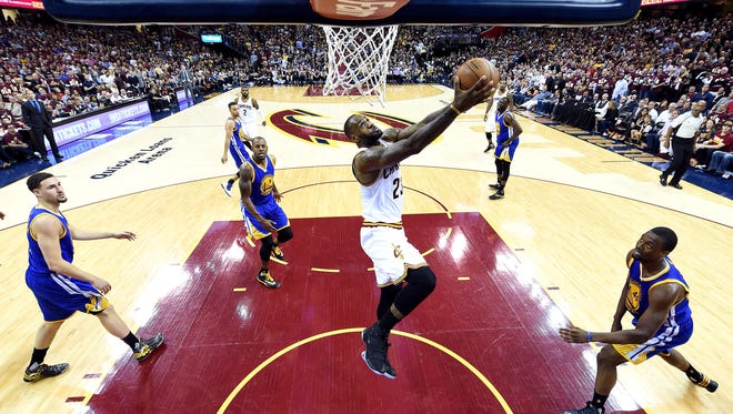 Cleveland Cavaliers forward LeBron James (23) dunks the ball against the Golden State Warriors in Game 3 of the NBA Finals at Quicken Loans Arena.