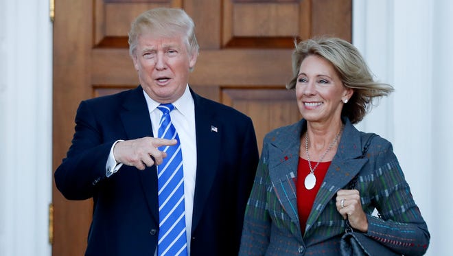 Betsy DeVos, a strong advocate of school choice and school vouchers, with Donald Trump on Nov. 19, 2016.