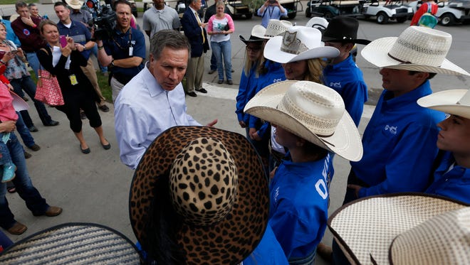Kasich talks with members of the Ohio junior high rodeo team at the National Junior High Finals Rodeo at the Iowa State Fair Grounds on June 24, 2015, in Des Moines.