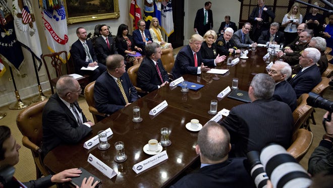 President Donald Trump speaks with county sheriffs at the White House on Feb. 7. In Collier County, some deputies have been delegated the responsibilities of immigration officers.