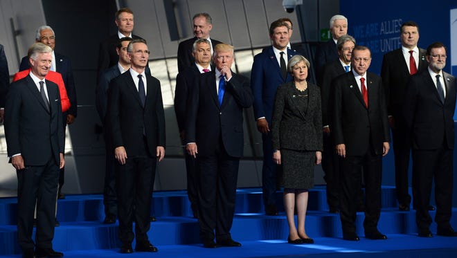 President Trump, center, flanked by British Prime Minister Theresa May, third from right, and NATO Secretary General Jens Stoltenberg, second from left, joins fellow leaders in a group photo at NATO headquarters during the NATO Summit in Brussels, Belgium on May 25, 2017.