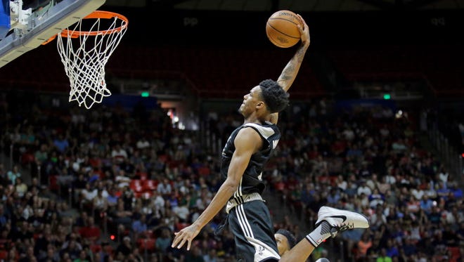 San Antonio Spurs guard Dejounte Murray (5) dunks the ball against the Utah Jazz during the first half of an NBA Summer League game in Salt Lake City.