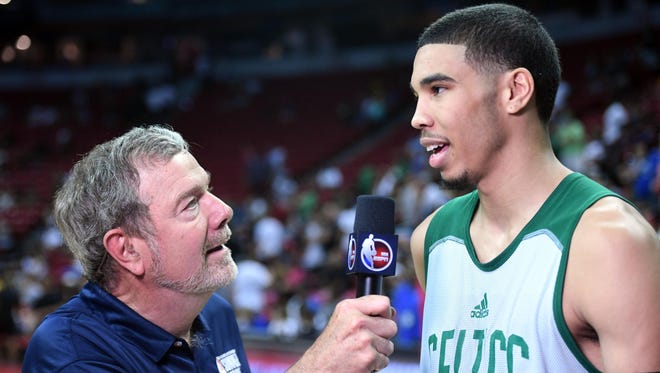 Boston Celtics forward Jayson Tatum (11) is interviewed by P. J. Carlesimo
after the second half against the Portland Trail Blazers at Thomas & Mack Center.