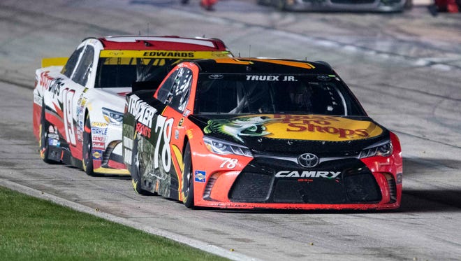 Round 3: Carl Edwards (19) follows Martin Truex Jr. (78) down pit road at Texas Motor Speedway. Edwards bested Truex on their final pit stop to take the race lead before the rain fell again a short time later.
