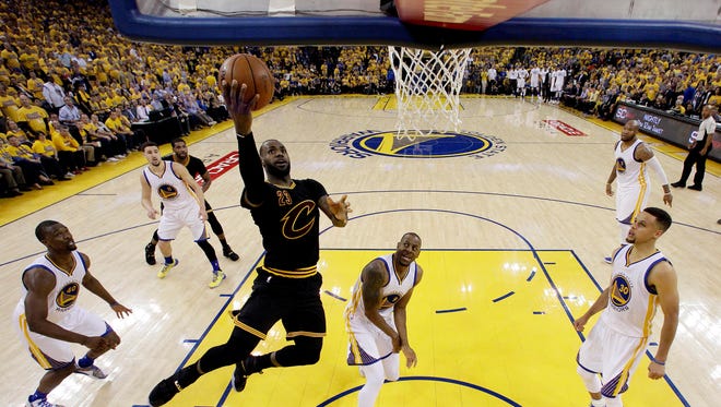 Cleveland Cavaliers forward LeBron James (23) shoots the ball against Golden State Warriors forward Andre Iguodala (9) in Game 5 of the NBA Finals at Oracle Arena.