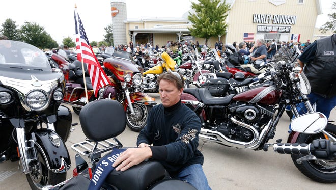 Mark Muerner of Norwalk gets his bike ready Saturday, Aug. 27, 2016, as he gets ready to head out in the second annual Roast and Ride fundraiser in Des Moines.