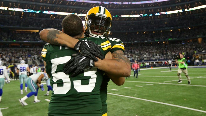 Green Bay Packers outside linebacker Julius Peppers (56) and outside linebacker Nick Perry (53) celebrate after beating the Dallas Cowboys in the NFC Divisional playoff game at AT&T Stadium.
