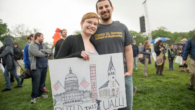 Evangelina Furton and Matt Lizzio, of Gaithersburg, Md., carry a sign on the National Mall for the March for Science in Washington.