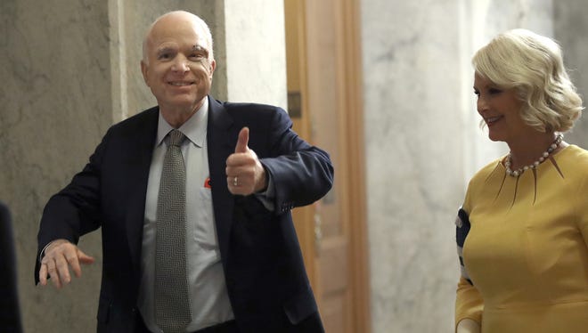 Sen. John McCain returns to the U.S. Senate accompanied by his wife Cindy on Tuesday. McCain was recently diagnosed with brain cancer but returned on the day the Senate is holding a key procedural vote on U.S. President Donald Trump's effort to repeal and replace the Affordable Care Act.