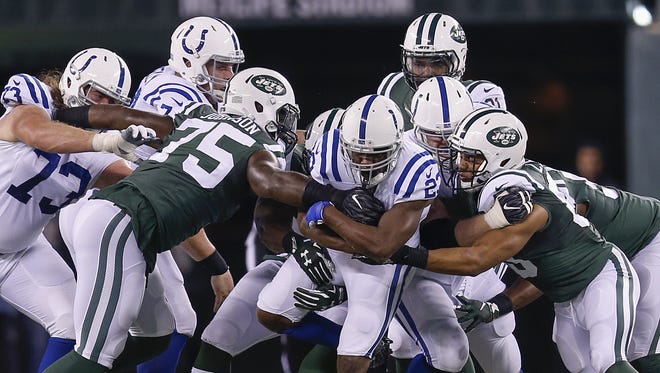 Indianapolis Colts running back Frank Gore (23) battles for yardage against the New York Jets during the 1st half at MetLife Stadium in East Rutherford, N.J., on Monday, Dec. 5, 2016.
