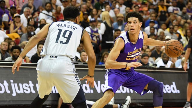 Los Angeles Lakers guard Lonzo Ball (2) dribbles away from Dallas Mavericks guard Corey Webster (19) during an NBA Summer League playoff game.