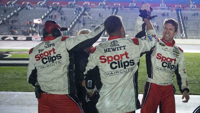 Round 3: Carl Edwards, right, celebrates with his crew after being declared the winner of the Chase for the Sprint Cup race at Texas Motor Speedway on Nov. 6. The win clinches a berth in the title race for Edwards.