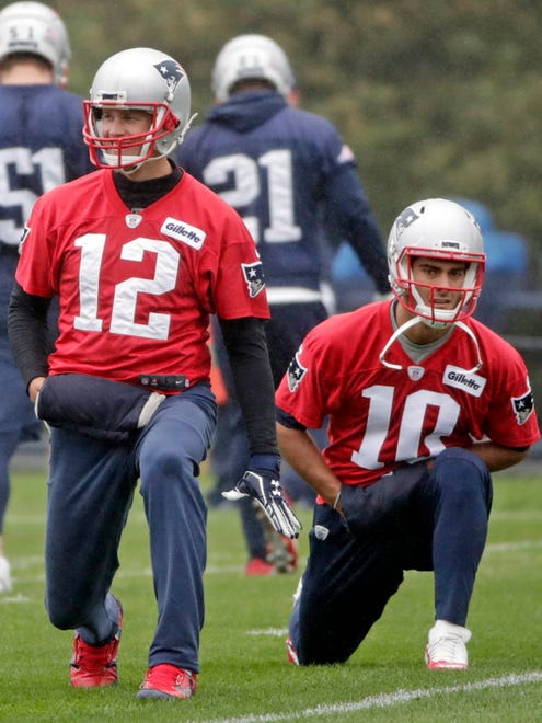 New England Patriots quarterbacks Tom Brady and Jimmy Garoppolo warm up during practice  in Foxborough, Mass.