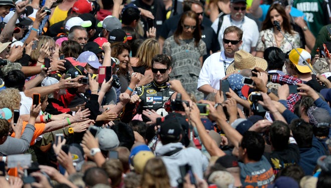 Gordon navigates the crowd before the Sprint Cup race at Auto Club Speedway in Fontana, Calif., on March 22, 2015.