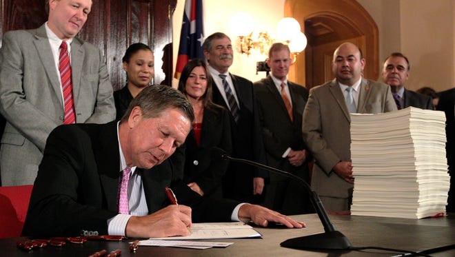 Kasich signs Ohio's 2016-2017 operating budget on June 30, 2015, in Columbus. Kasich said the $71.2 billion, two-year state budget helps people without getting "loose" with the spending.