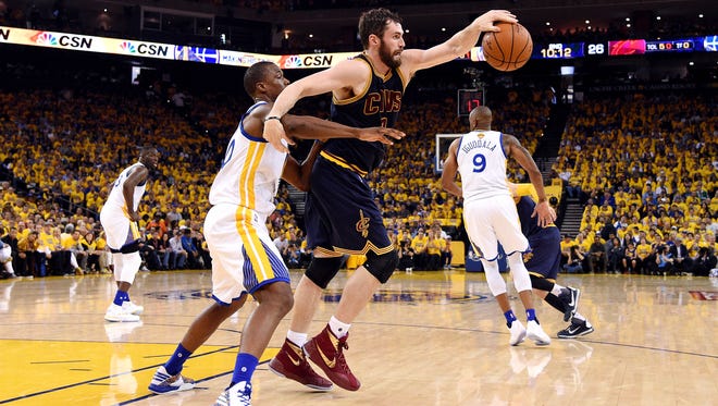 Cleveland Cavaliers forward Kevin Love (0) grabs a pass against Golden State Warriors forward Harrison Barnes (40) during the second quarter in game one of the NBA Finals at Oracle Arena.