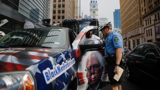 A police officer argues with a supporter of Democratic presidential candidate Bernie Sanders during Pennsylvania's primary on April 26, 2016.